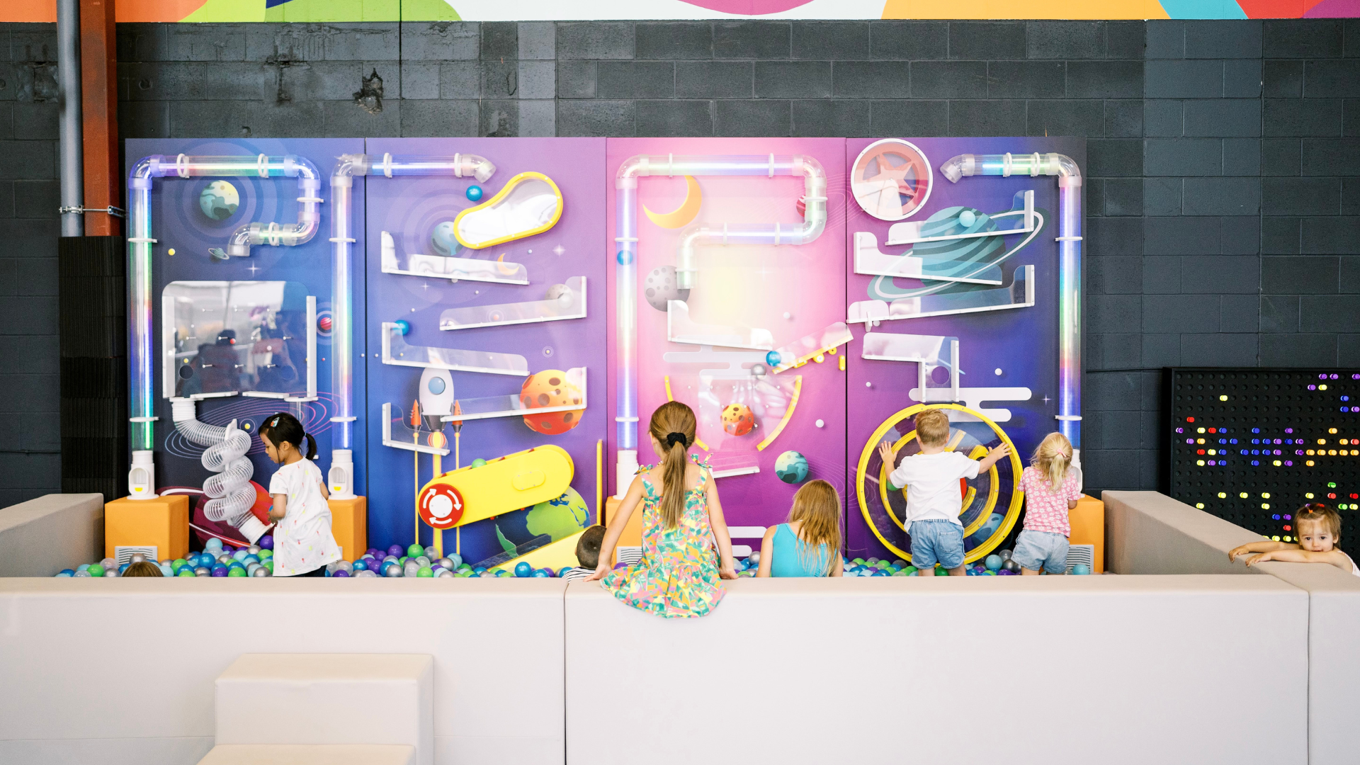 A birthday party at play area with colourful balls and toys